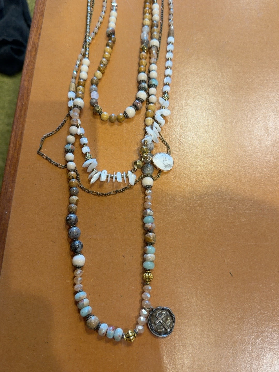 Layered brown and ivory beaded necklace with charms