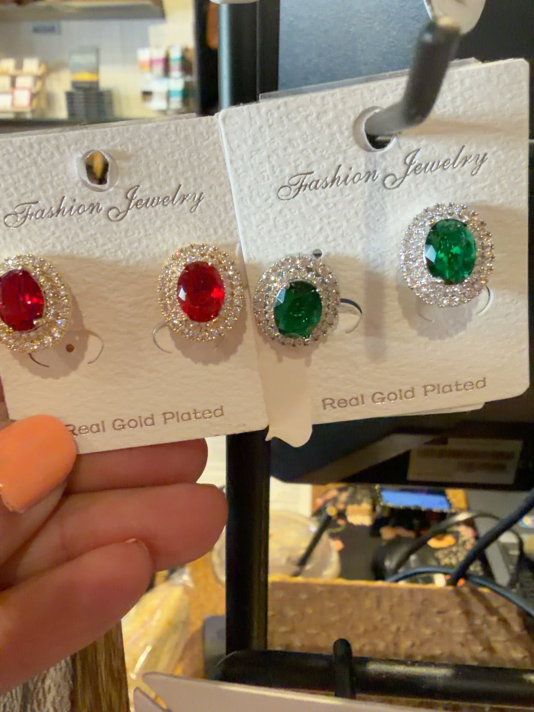 Red and green crystal stud earrings with sparkling halos