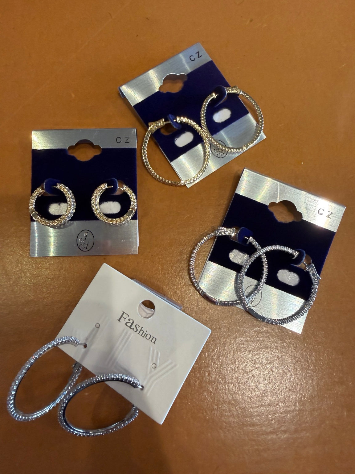 CZ hoop earrings in gold and silver finishes